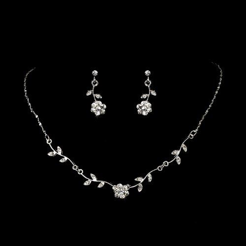 a necklace and earring set on a black background