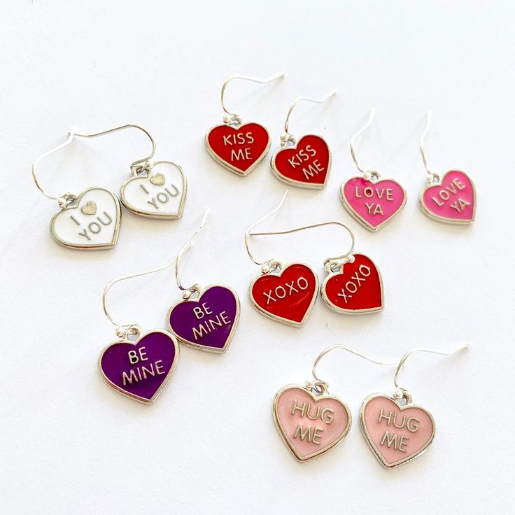 "These love heart earrings are super cute! Choose from a range of colors and sayings - perfect for Valentine's Day. The enameled metal hearts hang on silver plated ear wires. See photo 6 for an idea of size but please note that the \"Hug me\" earrings I have left in stock are slightly larger in size. These romantic earrings make a wonderful gift year round but are wonderful for Valentine's Day. They will be packaged in an organza bag ready for gift giving.  Holiday Happy Dance is a festive and f Metal Hearts, Hearts Earrings, The Hug, Red Heart Earrings, Romantic Earrings, Earrings Heart, Fun Jewelry, Happy Dance, Metal Heart