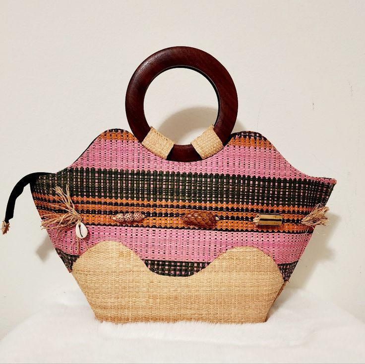 Woven African Hand-Made Bag. The Handel Bag Is Made With Wood. The Inside Has A 1 Zipper Closure Pocket And 1 Open Pocket. It Is New. Open For More Questions Pink Large Capacity Bucket Bag With Top Handle, Pink Handheld Bucket Bag With Large Capacity, Large Capacity Pink Shoulder Beach Bag, Large Capacity Pink Beach Shoulder Bag, Pink Large Capacity Handheld Satchel, Pink Handheld Satchel With Large Capacity, Pink Beach Bag With Adjustable Strap For Travel, Pink Top Handle Straw Bag For Beach, Pink Handheld Bucket Bag