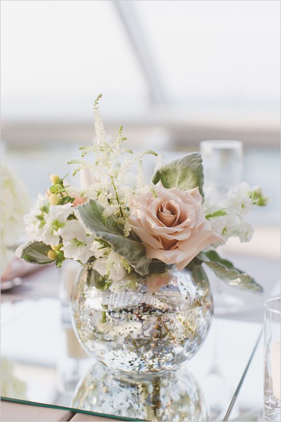 a vase filled with flowers sitting on top of a table