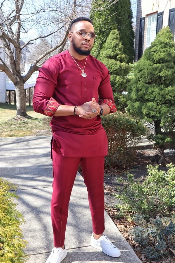 If you love to standout in the midst of other men then this outfit is for you! This is a unique classy African inspired outfit. Meticulously tailored with high quality Intalian fabrics. It comes with a top and a matching pant. Tailored to fit nicely (not too tight and not too loose). Available in Burgundy African Wear Men, Formal Long Sleeve Pant Set For Eid, Traditional Fitted Pant Set With Long Sleeves, Traditional Long Sleeve Semi-formal Sets, Fitted Long Sleeve Kaftan For Formal Occasions, Formal Fitted Long Sleeve Kaftan, Formal Long Sleeve Kurta With Traditional Patterns, Traditional Long Sleeve Sets For Groom, Traditional Fitted Agbada With Long Sleeves