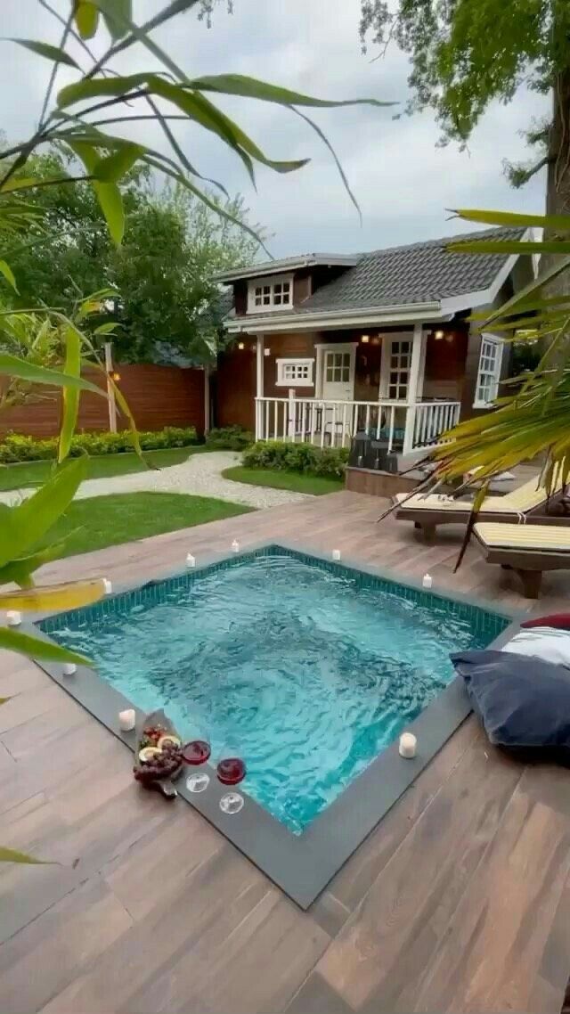 an empty pool in the middle of a wooden deck