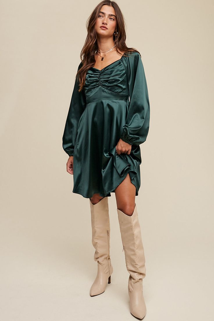 -Color: Deep Green -Cinched long sleeve satin dress -Sweetheart neckline with elastic -Stretched -Long puff sleeves with elastic cuffs -Smocking on back -A-line skirt -Hidden side seam pockets -Finished with clean hem -Lined -Imported -Content: 95% Polyester 5% Spandex -Model is 5' 7" 31-24-35 and wearing a size Small Fall Satin Mini Dress Knee-length, Long Sleeve Satin Mini Dress For Fall, Fall Knee-length Satin Mini Dress, Long Sleeve Satin Dress For Fall Date Night, Fall Long Sleeve Satin Dress For Date Night, Ruched Balloon Sleeve Dresses For Night Out, Satin Long Sleeve Midi Dress With Pleated Sleeves, Satin Midi Dress With Pleated Long Sleeves, Long Sleeve Satin Midi Dress With Pleated Sleeves