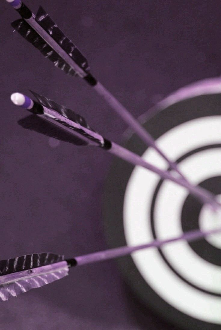 three arrows are in the middle of a dart with an arrow pointing towards it, on a purple background