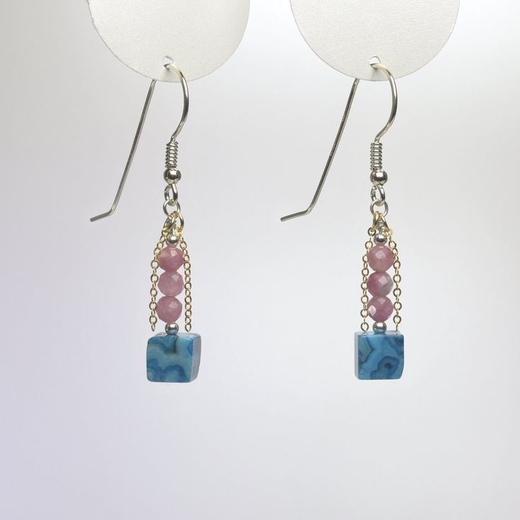 "These gemstone dangle earrings are handmade using blue crazy lace agate cubes and faceted pink tourmaline beads. Part of my \"Touch of Gold\" series, they are accented with segments of gold filled flat chain which flicker in the light. They're sure to attract attention. The sterling silver ear wires are also carefully handmade. Length: 1.75\" (44 mm) from top of ear wire. See image with ruler. Width: 0.25\" (6 mm) Dimensions are approximate. Crazy Lace Agate is named for its swirling and circul Blue Agate Dangle Jewelry, Blue Agate Earrings As A Gift, Rectangular Jewelry With Dangling Beads For Gifts, Gift Jewelry With Dangling Rectangular Beads, Pink Square Jewelry For Gifts, Pink Square Jewelry Gift, Handmade Square Pink Jewelry, Handmade Pink Square Jewelry, Northern Mexico