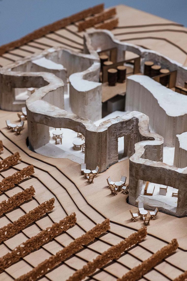 a model of a city with buildings made out of concrete blocks and wood slats