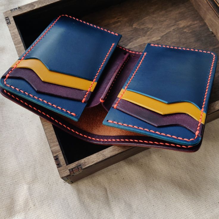 "This vertical leather wallet is designed for your joy and convenience. Joyful colors will give a good mood even on the most cloudy day. It is quite compact but roomy. You can always take six cards with you, the required number of banknotes, and there will still be two secret compartments for cards, checks, or banknotes. The Bifold Middle Wallet is made exclusively by my hands. I don't use a sewing machine and a press. Every detail is cut, sanded and sewn by my hands. You can be sure that you ar Joyful Colors, Leather Wallet Design, Cash Holder, Handmade Wallets, Handmade Leather Wallet, Wallets For Women Leather, Clip Wallet, Veg Tan Leather, Wallet Gifts