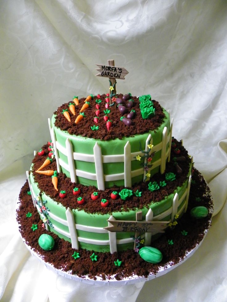 a three tiered cake is decorated with green frosting and farm animals on it