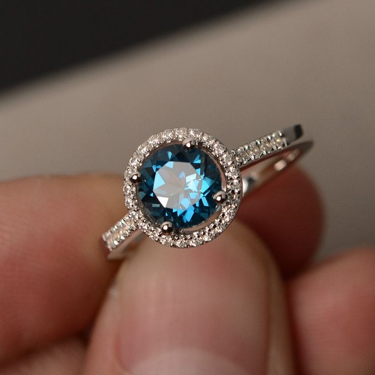 This is a gorgeous handmade creation. Its beauty is its simplicity & Elegance. The 7*7mm round cut London blue topaz is crafted in solid sterling silver and with rhodium plated. All item is sent in a beautiful gift box You can realize more lovely stuff clicking the link https://www.etsy.com/shop/knightjewelry?refshopsection_shophome_leftnav Please leave the correct address and you phone number for delivering successfully. Sterling Silver Topaz Ring With Halo Design For Promise, Elegant Round Topaz Crystal Ring, Sapphire-colored Blue Topaz Ring In Round Cut, Fine Jewelry Blue Topaz Ring With Round Stone, Sapphire Blue Topaz Ring With Round Cut, Gift Topaz Ring With Halo Setting In Sterling Silver, Fine Jewelry Topaz Ring With Birthstone, Topaz Crystal Ring With Halo Setting Gift, Silver Topaz Crystal Ring