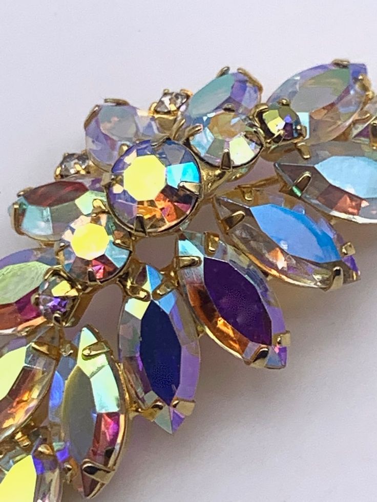 Iridescent Brooch Jewelry For Party, Elegant Multicolor Brooches For Evening, Gold Crystal Brooches For Party, Party Crystal Brooches Costume Jewelry, Elegant Multicolor Jeweled Brooches, Multicolor Costume Jewelry Brooches For Weddings, Party Crystal Brooches With Sparkling Stones, Crystal Brooches With Sparkling Stones For Party, Party Brooches With Sparkling Crystal Stones