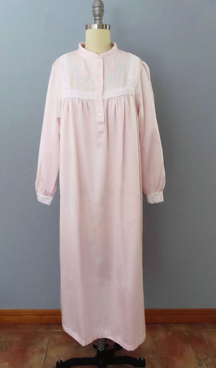 Vintage nightgown from the 80's era!! Pale pink with floral embroidered chest and lace cuffs. Feels like cuddleskin with a satin outside and and soft cotton inside. Button up top bodice. Right hip pocket. This robe is made to stay warm and to cuddle!   Fits a medium-large frame but please double-check the measurements below to ensure the best fit for you.  -- M E A S U R E M E N T S --- Bust: 46" Waist: 50" Hips: 50" Shoulders: 15" Arm Opening: 16" Sleeves: 22" Length: 45" Fabric: Polyester, cotton Label/Era: Gsoftly / 1980 Stated Size: S Condition: Great vintage condition. Freshly laundered. No issues.  ★ Enter the Shop here https://www.etsy.com/shop/RetroSuzysVintage Instagram | retrosuzysvintage Pinterest | retrosuzysvintage Pink Feminine Robe For Sleepover, Feminine Pink Robe For Sleepover, Feminine Long Sleeve Robe For Home, Feminine Long Sleeve Home Robe, Vintage Pink Robe For Loungewear, Feminine Long Sleeve Robe For Daywear, Long Sleeve Pink Nightgown For Spring, Pink Vintage Sleepwear, Long-sleeved Pink Vintage Robe