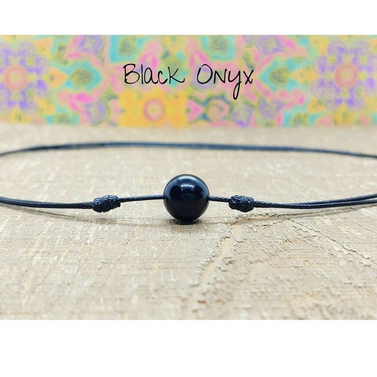 Minimalist Adjustable Choker Necklace made with a 10mm Black Onyx Stone on Strong Waterproof Nylon Cording. This striking onyx choker necklace is like many necklaces in one.  It can be worn short, as a choker, all the way to a 26 inch necklace.  The cord has 2 sliding knots which makes adjusting this necklace very easy and smooth, and you can wear it at any length to compliment all your outfits. The necklace is strong and sturdy and will hold up well to your daily activities including in the gym Handmade Black Jewelry With Nylon Cord, Handmade Black Nylon Cord Jewelry, Minimalist Necklace With Adjustable Waxed Cord, Minimalist Necklace With Adjustable Length And Waxed Cord, Minimalist Adjustable Choker Necklace, Minimalist Jewelry With Adjustable Waxed Cord, Black Casual Necklace With Adjustable Cord, Minimalist Adjustable Waxed Cord Jewelry, Casual Black Necklace With Adjustable Cord