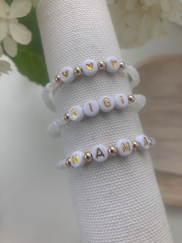 Single bracelet | 14k gold filled beaded bracelet | 4mm gold filled beads | 4mm natural moonstone beads | white and gold letter/number beads | elastic beaded bra meet | please include custom word, initials, numbers in notes to seller Dainty White Stretch Bracelet With Gold Beads, Minimalist White 14k Gold Filled Beaded Bracelets, Adjustable White Name Bracelet With Gold Beads, Adjustable White Beaded Bracelets In 14k Gold Filled, White Beaded 14k Gold-filled Bracelets, White 14k Gold Filled Beaded Bracelets For Gifts, White 14k Gold-filled Beaded Bracelets As Gift, White 14k Gold Filled Beaded Bracelets, White 14k Gold-filled Beaded Bracelets