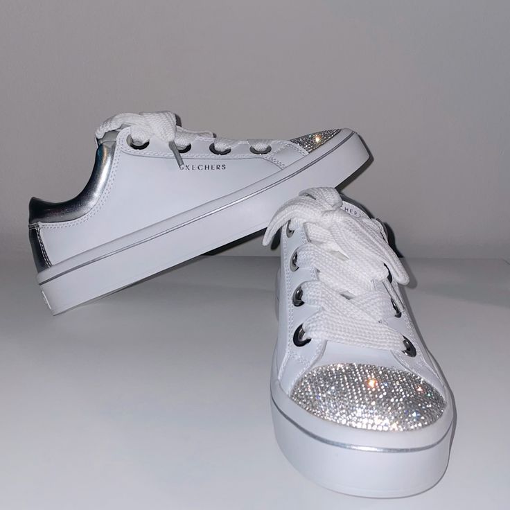 Skechers Rhinestone Sneakers. Air Cooled Memory Foam Insole. Extremely Comfortable. True To Size. Great For Longer Wear. Would Be A Great Option For A Wedding Or To Change Into Even At A Formal Event. Brand New. Never Worn. Casual Bedazzled Sneakers, Trendy White Sneakers With Glitter Accents, Casual White Embellished Sneakers, Bedazzled Synthetic Sneakers With Round Toe, Silver Bedazzled Low-top Sneakers, Streetwear Sneakers With Rhinestones And Round Toe, White Rhinestone Round Toe Sneakers, Bling Sneakers With Round Toe For Streetwear, Bedazzled Low-top Synthetic Sneakers