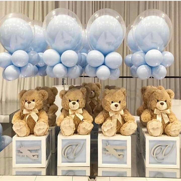 four teddy bears are sitting on pedestals with balloons in the shape of letters and numbers