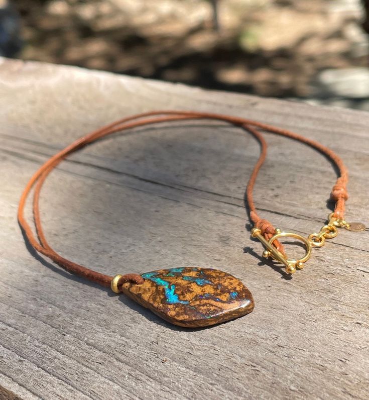 This necklace features a stunning Australian Opal pendant, non-toxic leather (dyed with vegetable dye), and Solid 18k Gold. That's it, 3 high quality materials come together for a simple, natural & minimal necklace. Each one of my gold necklaces is stamped with an 18k gold hallmark.  This Boulder Opal necklace was handmade by me in Oregon. It's part of my latest collection of solid gold and leather gemstone jewelry. I normally work in sterling silver, but lately gold has been calling to me. This necklace measures 18 inches Boulder Opal pendant measures 30mm (1.25 inches) As with most jewelry, it is best to remove when bathing or swimming. Artisan Leather Necklace For Everyday, Artisan Gold Jewelry With Adjustable Cord, Handmade Leather Lariat Jewelry, Gold Leather Necklace For Gift, Gold Leather Necklace For Everyday Use, Everyday Gold Leather Necklace, Brown Pendant Jewelry For Everyday Use, Everyday Use Brown Pendant Jewelry, Artisan Gold Necklace With Adjustable Cord