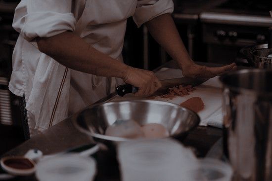 a chef is preparing food in the kitchen