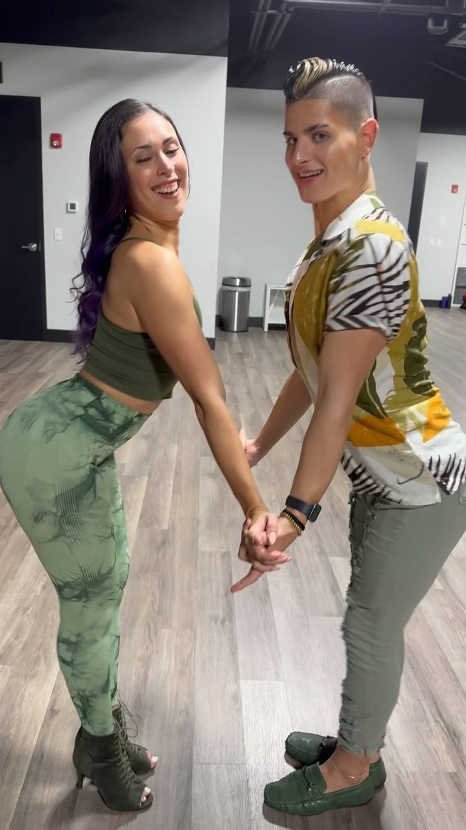 two young women are dancing together on the dance floor