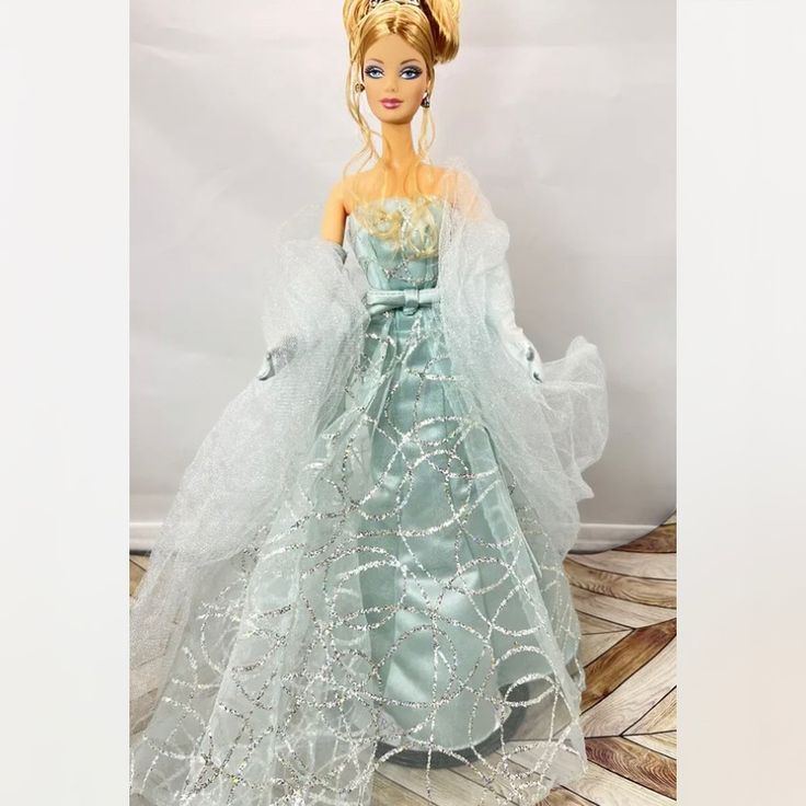 a barbie doll wearing a blue dress and tiara