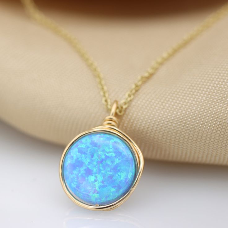 A beautiful large Opal necklace is the perfect statement piece. Set with a genuine 10 mm blue Opal gemstone Most recommended as a set with our beautiful Blue Opal ring :) Link: https://www.etsy.com/il-en/listing/879805308/blue-opal-knot-ring-handmade-ring-opal?ref=shop_home_active_5&pro=1&frs=1 ☆ WHY THIS PIECE OF J E W E L R Y IS AWESOME! ☆ * Hand finished and made from high quality raw materials * Available in Gold filled, Red gold Filled or Sterling Silver * Long lasting beauty & Gold Opal Jewelry With Round Stone, 14k Gold Wire Wrapped Necklace As Gift, 14k Gold Wire Wrapped Necklace For Gift, Blue Gemstone Jewelry For Birthday Gift, Gold Opal Round Necklaces, Gold Opal Round Necklace, Opal Birthstone Round Necklaces, Round Opal Birthstone Necklaces, 14k Gold-filled Round Birthstone Necklaces