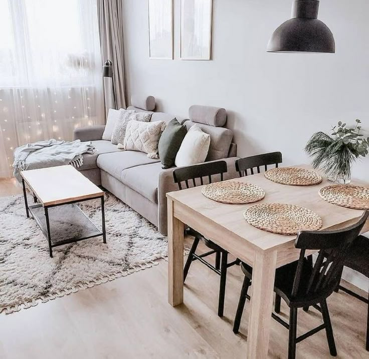 a living room filled with furniture and a wooden table in front of a couches