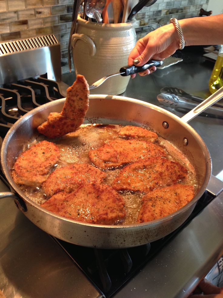 someone is frying some food in a pan on the stove