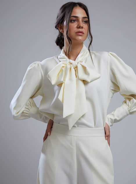 Chic Tops With Detachable Bow For Spring, Chic White Blouse With Bow Detail, Chic White Blouse With Bow, White Tie Neck Top With Tie Sleeves, Chic White Blouse With Tie Sleeves, White Bow Blouse For Work, White Bow Blouse For Workwear, White Tie Sleeves Top For Daywear, White Tops With Tie Sleeves For Daywear