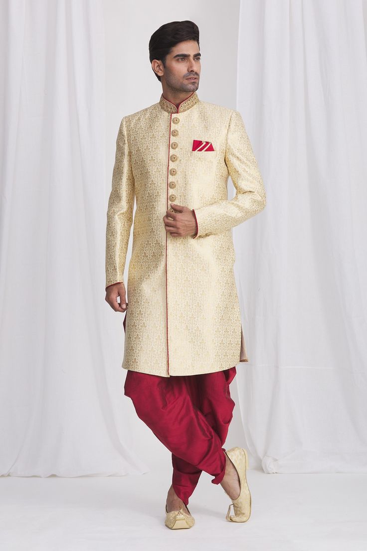 Gold sherwani in jacquard silk brocade base fabric featuring floral motifs and embellished button details. Paired with contrast dhoti pant.
Component: 2
Neckline: Mandarin
Sleeve Length: Full
Fabric: Sherwani: Jacquard Silk Brocade; Dhoti: Dupion Art Silk; Lining: Faux Satin
Color: Gold
Front overlap panel
Embellished button details
Elasticated and drawstring waistband
Note: The pocket square worn by the model is for styling purpose only - Aza Fashions Gold Sherwani, Dhoti Pants, Gold Fronts, Gold Silk, Silk Brocade, Satin Color, Fashion App, Buy Gold, Floral Motifs