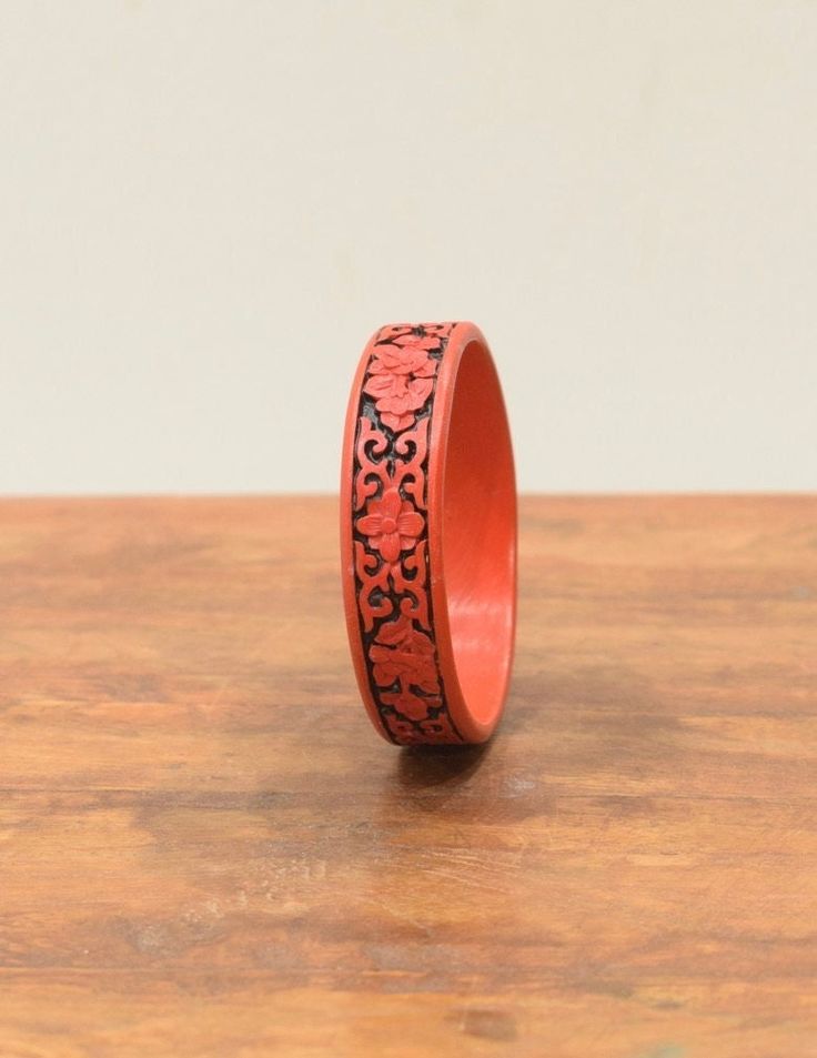 A wonderful Flat Red and Black Chinese Cinnabar Cloud Design Bangle Bracelet. The Bracelets have a motive of flowers and vines around the rim and have been in fashion for hundreds of years. Simple, Elegant style the bracelets would be a wonderful way accessorize to your Jewelry Collection. Sold Individually Bracelet 3.5 Inches Wide 1 Inch Deep 3.5 Inches Diameter AT BACARA WE STAND BEHIND ALL OF OUR MERCHANDISE.FULL MONEY BACK GUARANTEE WILL BE PROVIDED FOR DISSATISFIED CUSTOMERS. YOUR SATISFACT Simple Elegant Style, Cloud Design, Beaded Cuff Bracelet, Clouds Design, Beaded Cuff, Simple Elegant, Design Floral, Bangle Bracelet, Elegant Style