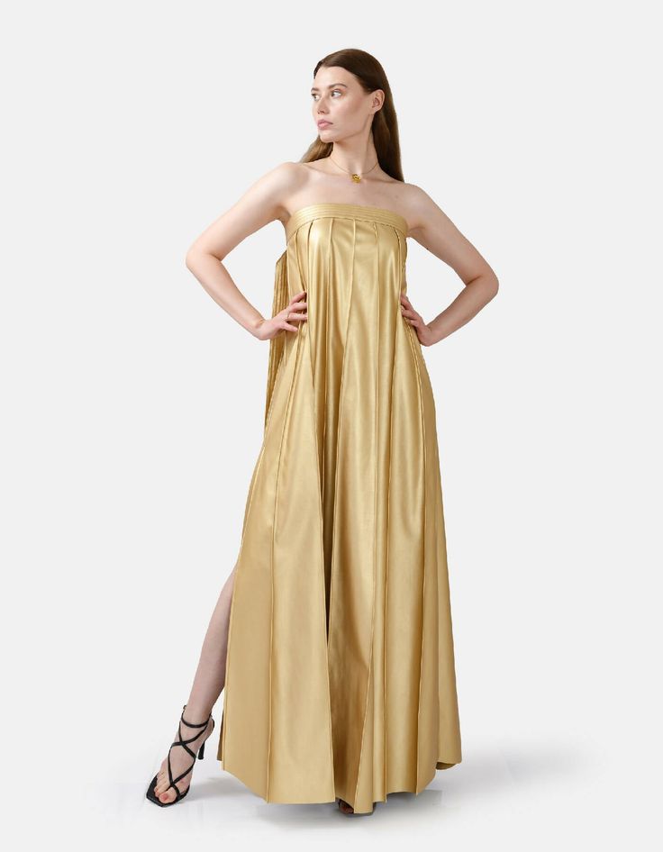 Chic, comfortable and edgy, this gold strapless pleated maxi dress offers a highly flexible fit with an adjustable button closure at back. Dress comes in ankle length or floor length, refer to size guide for dress length. High rise pleating, gold button details, and a stylistic belt tie at the bust add flare to the designs minimalist charm. The medium weight fabric, cruelty free vegan leather, has a loosely structured drape for a relaxed and remarkably comfortable fit. You'll be kept warm in coo Belt Tie, Strapless Maxi, Strapless Maxi Dress, Pleated Maxi Dress, Pleated Maxi, Back Dress, Dresses Xs, Keep Warm, Medium Weight