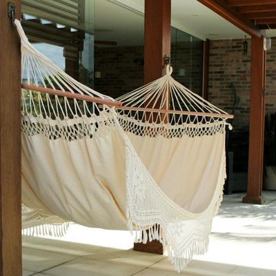 two hammocks are hanging on the porch