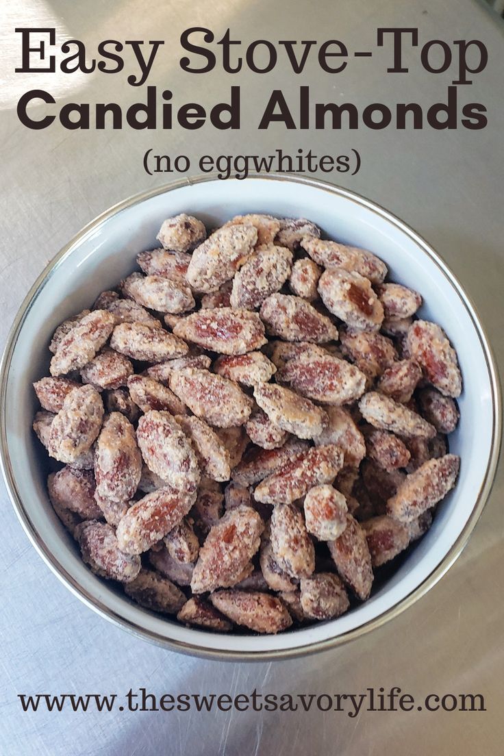 a bowl filled with candied almonds sitting on top of a table