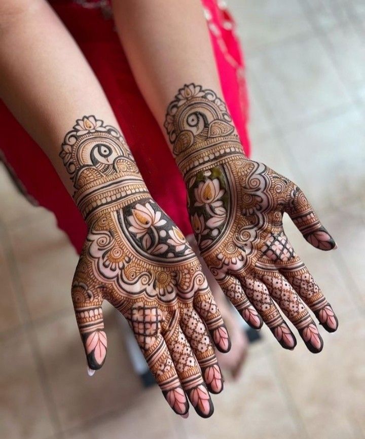 two hands with henna tattoos on them