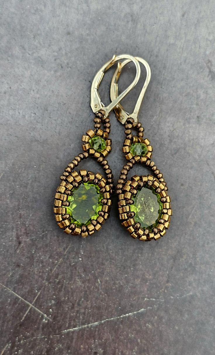 These earrings feature one pair of faceted, sparkling, vibrant green Peridot centerpieces. With Peridot beads, and 14k gold-filled leverback findings. Elegant Beaded Earrings With Oval Beads, Elegant Oval Beaded Earrings, Elegant Handmade Oval Beaded Earrings, Elegant Teardrop Spacer Beads Jewelry, Handmade Oval Beaded Earrings, Jewelry Making Bead Caps Teardrop, Peridot Earrings, Sky Blue Topaz, Green Peridot