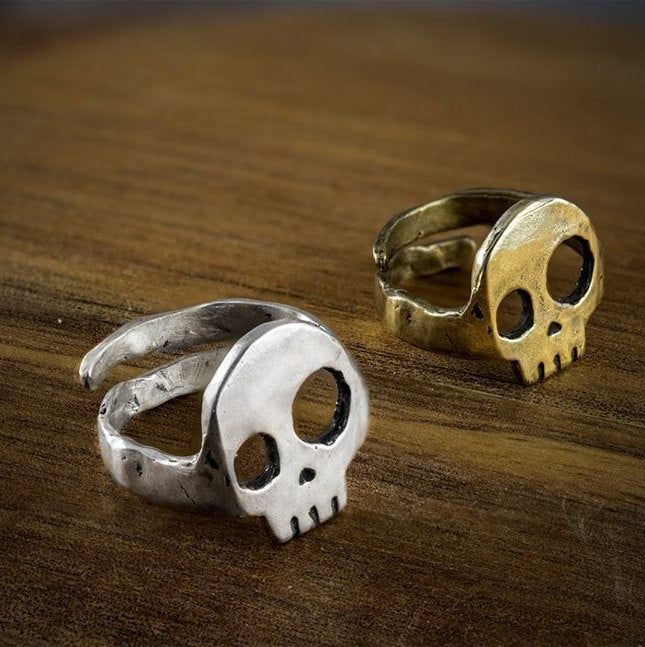 "Ajustable Skull ring This skull ring is a funny and casual skull adjustable ring in silver or golden brass. Tired of the clasic skull ring we've tried to do something diferent from the high detailed and heavy anatomical rings. It is melted, carved by hand and with a high quality finision. The adjustable skull ring is exclusively designed and sell in our shop. It is a funny design with asymmetrical eyes which makes you feel cool and awesome. The concurrent back in the ring allows a double functi Asymmetrical Eyes, Birthday Cake Smash, Iron On Vinyl, Skull Ring, Adjustable Ring, Adjustable Rings, Funny Design, Rings For Men, Ring Size