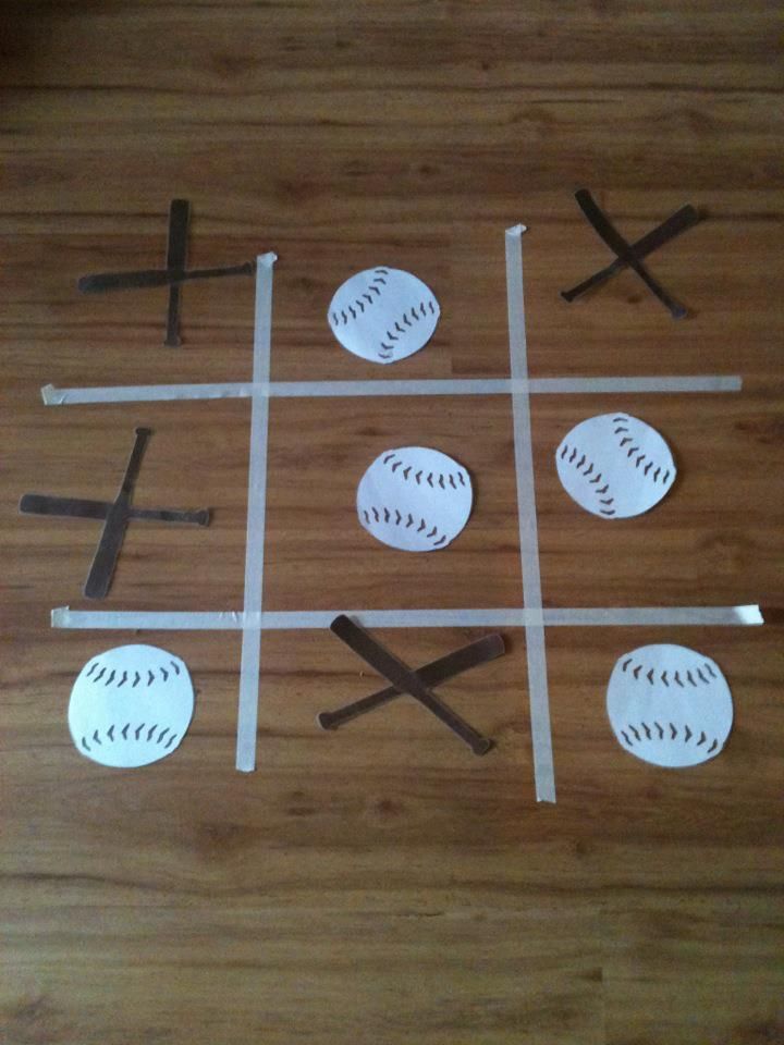 a ticquet made out of paper with baseballs and bats on the floor