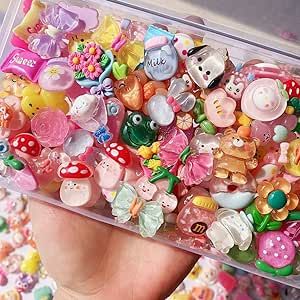 a hand holding a plastic container filled with lots of small buttons