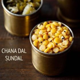 two small tins filled with corn sitting on top of a wooden table next to each other