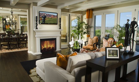 a living room filled with furniture and a fire place in the middle of it's walls