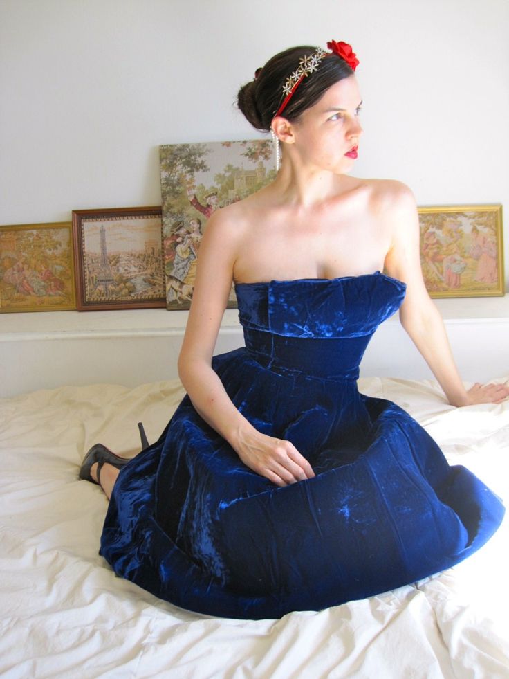 "By legendary mid-century design company Suzy Perette, this high-end piece is constructed from the most beautiful thick navy blue velvet. There's a wonderful weight to the skirt so it swings beautifully when dancing, catching the light and picking out the purple highlights in the velvet. The top is one of my favorite parts - best shown in the fourth photo, there's a top panel of velvet that juts out in a square shape for a fascinating architectural effect that really exemplifies the modernity of Fitted Blue Dress With Boned Bodice, Blue Fitted Corset Dress For Evening, Blue Strapless Corset Dress For Evening, Fitted Blue Corset Dress For Evening, Vintage Overbust Corset Dress For Evening, Blue Corset Dress With Boned Bodice For Evening, Blue Corset Dress With Boned Bodice For Formal Occasions, Vintage Fitted Corset Dress For Evening, Blue Corset Dress With Boned Bodice For Parties