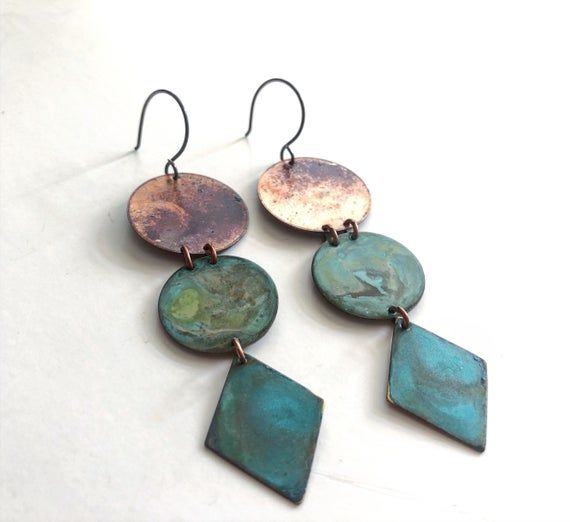 Brass naturally oxidized with our Verdigris and organic patina. Oxidized sterling silver ear wires.Measurement:1”x3.5”Care:All of our patina pieces are sealed with a resin lacquer to help protect the oxidization, however we do recommend that you keep all patina pieces dry and away from water as it can further the oxidation process and potentially can alter the color. *Patina is a natural oxidation process so color shades may vary. Patina Jewelry Ideas, Unique Green Patina Jewelry, Green Earrings With Oxidized Finish, Unique Green Earrings With Oxidized Finish, Unique Green Jewelry With Patina, Nickel-free Copper Artsy Jewelry, Artsy Copper Drop Earrings, Artsy Nickel-free Copper Jewelry, Artistic Bronze Jewelry With Ear Wire