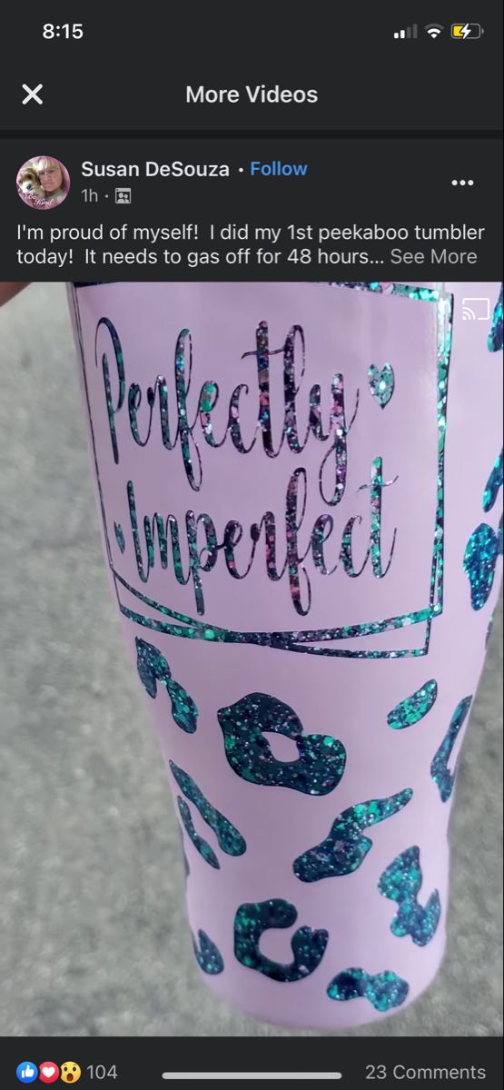 someone is holding a cup with the words perfectly imperfected printed on it in blue and green