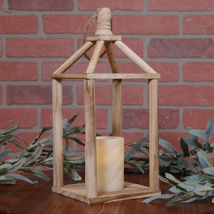 a small wooden lantern with a candle inside