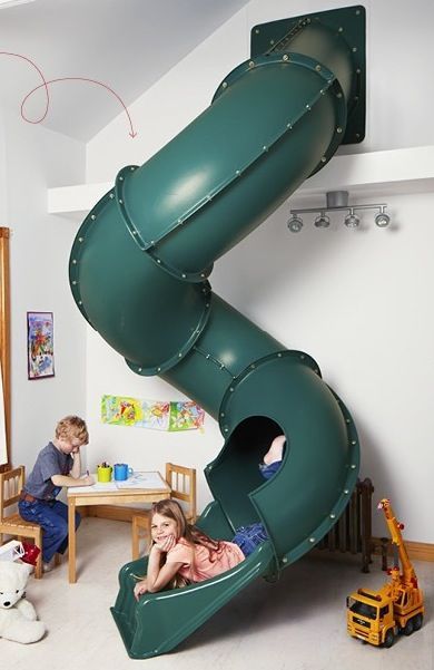 two children playing in a play room with a slide