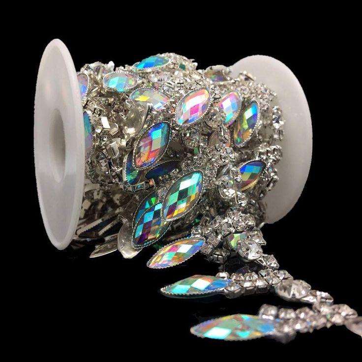 a roll of white ribbon with lots of crystal stones on it