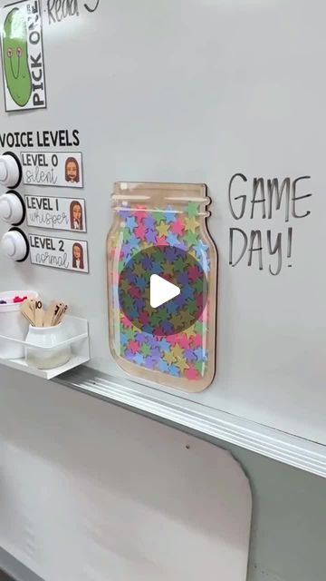 a video game day sign is on the wall in front of a whiteboard with stickers