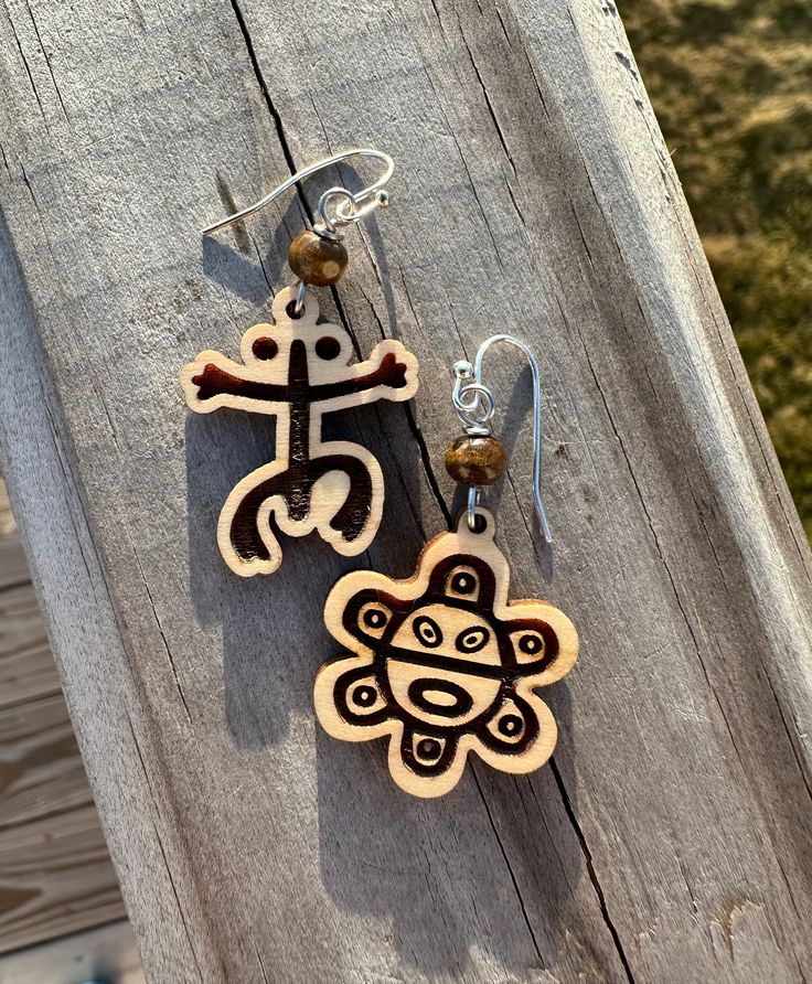 Discover the timeless beauty of our meticulously crafted wood engraved dangle earrings, each piece a homage to the rich Taino cultural heritage. At the heart of their design lies the iconic Taino symbols: the coqui, a revered symbol of resilience and identity, and the radiant sun, representing renewal and the circle of life. These symbols are intricately engraved on premium wood, capturing the essence of Taino artistry and spirituality. Each earring is thoughtfully finished with a small, polishe Taino Coqui, Taino Symbols, Meaningful Symbols, Puerto Rico Art, Sister Birthday Gift, Symbol Art, Gift For Sister, Circle Of Life, Sister Birthday