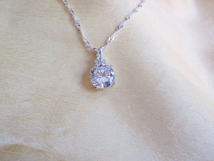 This 6.5 carat round brilliant Cz is accented with 3 small cz's and comes on a chain that  measures 18 inches in length and is .925 sterling.  The main stone is 9.5mm in width making this a great looking substitue for a more expensive stone. Expensive Stones, Cz Pendant, Round Brilliant Cut, Houston Tx, Round Brilliant, Pendant Necklaces, Jewelry Necklace Pendant, Houston, Jewelry Necklaces