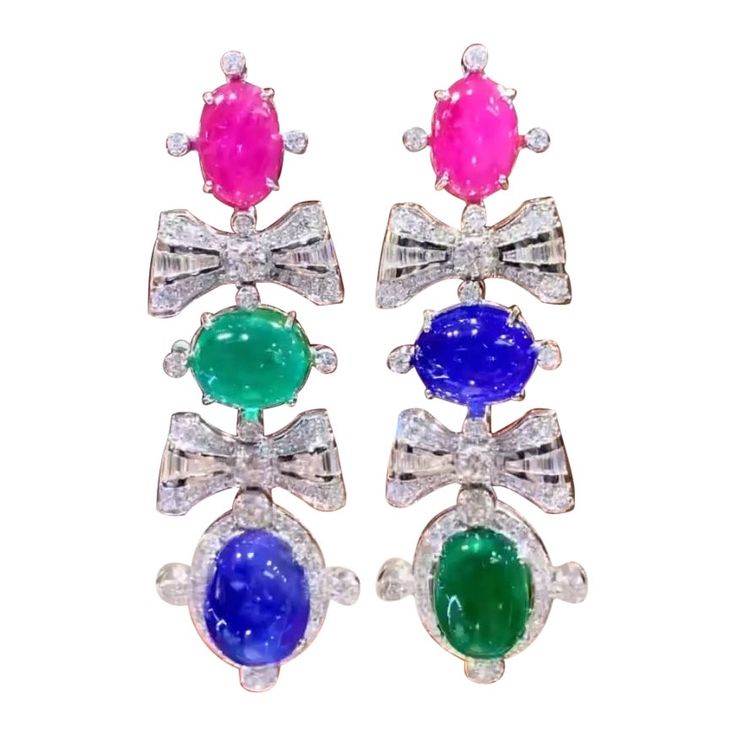 A multicolored pair of earrings, in sophisticated design, so fashionable and particular design, very adorable style. Earrings come in 18K with 2 pieces of Natural Zambian Emeralds , in perfect oval /cabochon cut of 22,00 carats, fine quality, stunning color , 2 pieces of Natural Tanzanites , in ideal oval/cabochon cut of 28,50 carats, fine quality, 2 pieces of Natural Burma Rubies in perfect oval /cabochon cut of 11,22 carats, fine quality, and 186 pieces of Natural Diamonds in round brilliant cut of 6,76 carats, F color VS clarity, so sparkly. Handcrafted by artisan goldsmith. Excellent manufacture and quality of stones . Complete with AIG report. Whosale price. Note: on my shipment, no taxes. Adorable Style, 18k Gold Earrings, Zambian Emerald, Sophisticated Design, Zambia, Style Earrings, Oval Cabochon, Color 2, Chandelier Earrings