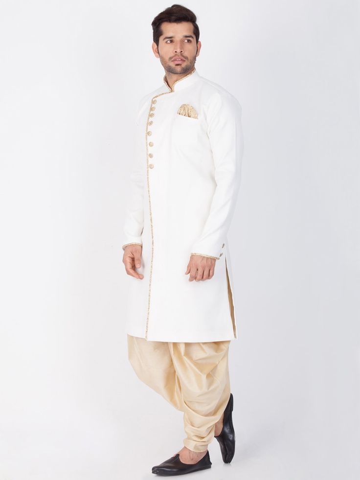 Vastramay Cotton Blend White and Gold Baap Beta Sherwani Set Get ready to stand out in this stunning sherwani set crafted with exquisite white and gold cotton blend fabric. Perfect for special occasions and celebrations, this set combines traditional elegance with modern style. Key Features: White solid angrakha style Indo-western sherwani Mandarin collar, long sleeves, full button placket Straight hem, welt pocket, side slits Comes with a pocket square Gold solid cowl style Patiala dhoti pant E Bollywood Style White Naqshi Salwar Kameez, White Salwar Kameez With Naqshi For Festivals, Festive White Churidar With Naqshi Detailing, White Naqshi Kurta For Festive Occasions, Traditional Gold Sherwani With Gota Work, White Naqshi Churidar For Festivals, Designer White Churidar With Naqshi Detailing, Festive White Nehru Jacket With Dabka, White Dabka Designer Traditional Wear